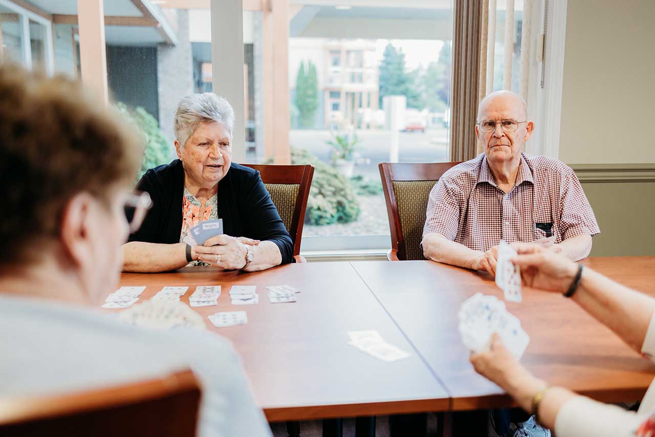 the wellington retirement residence happy seniors playing cards