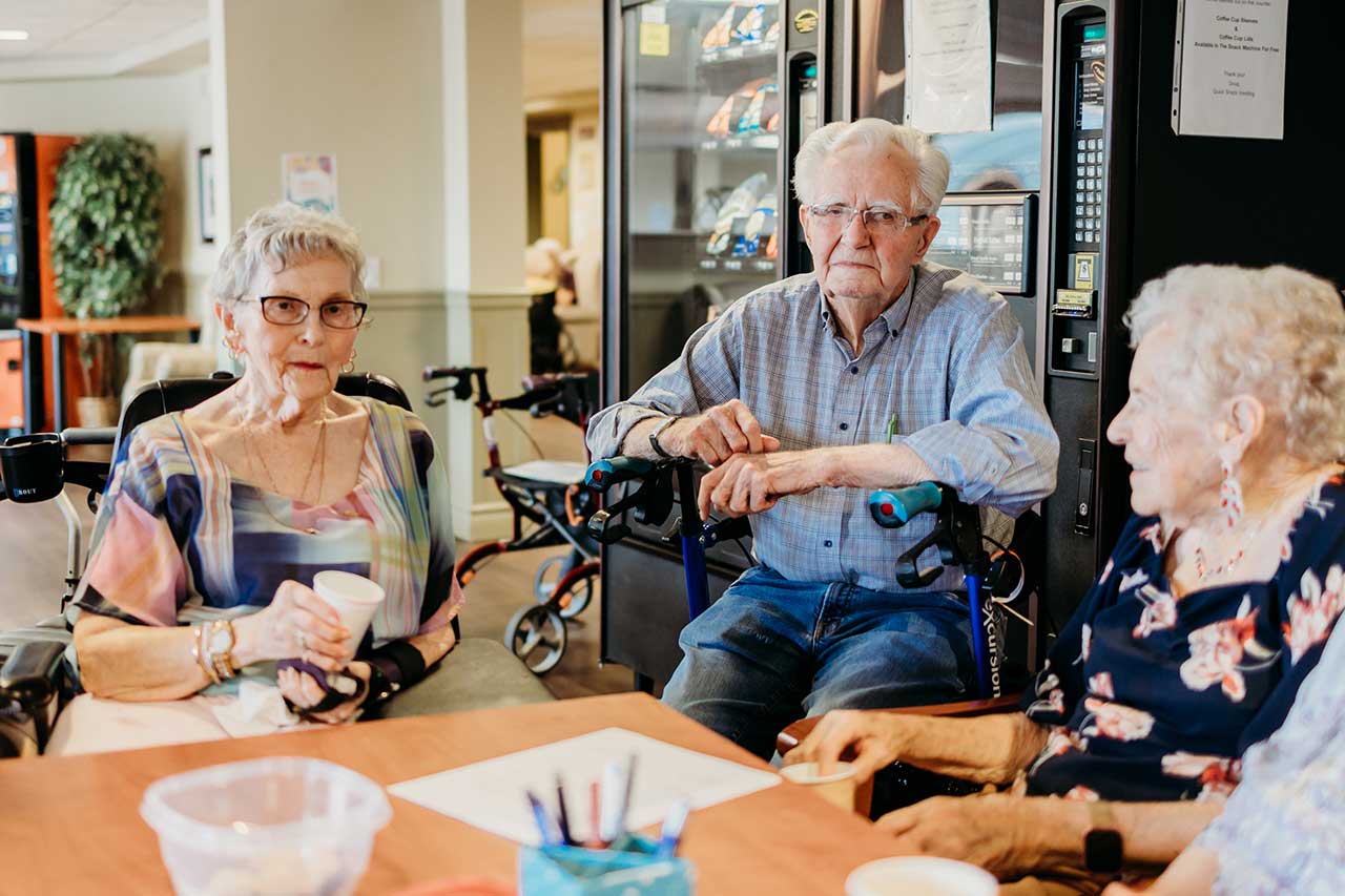 the wellington retirement residence happy seniors sitting at table