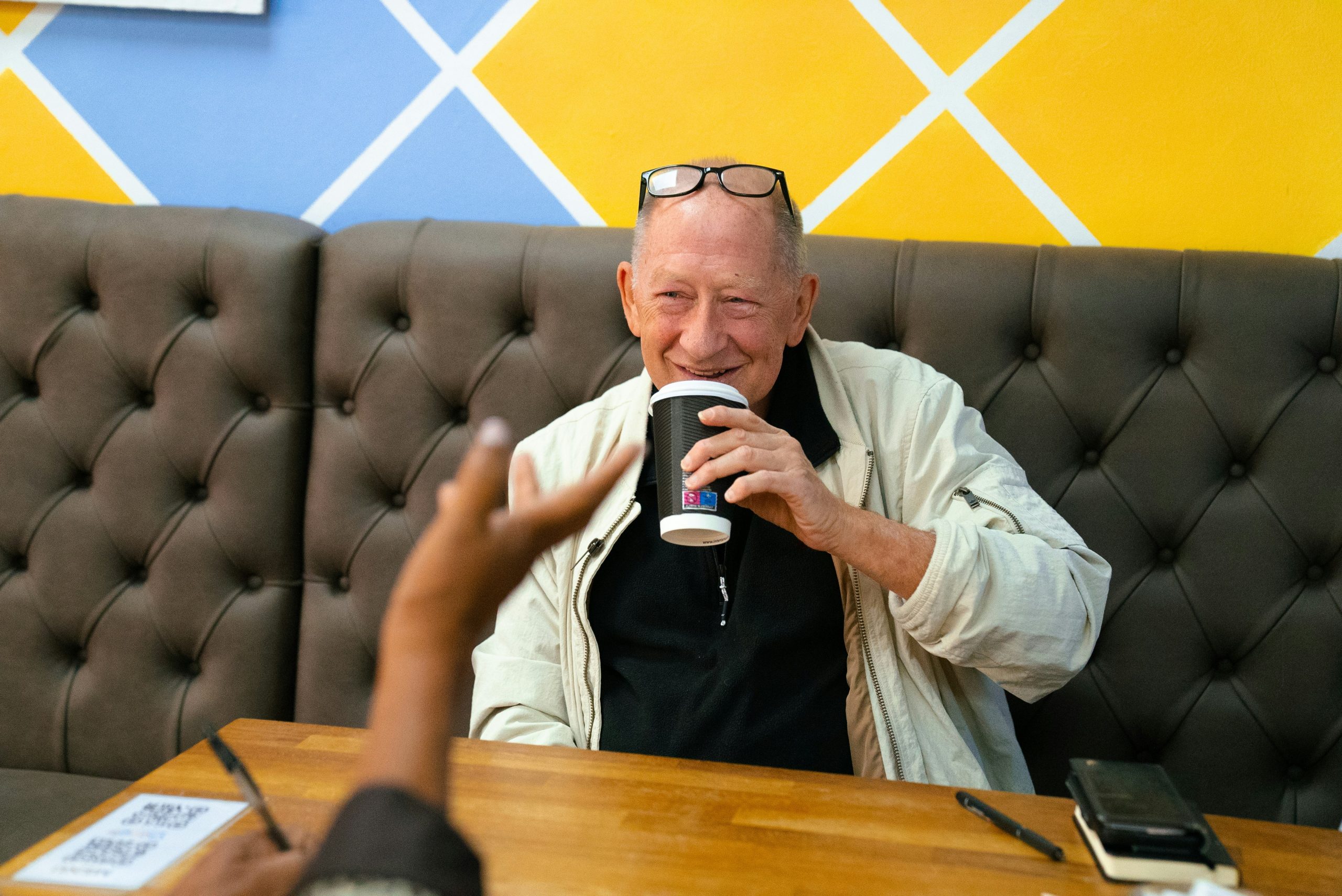 senior man drinking coffee at table