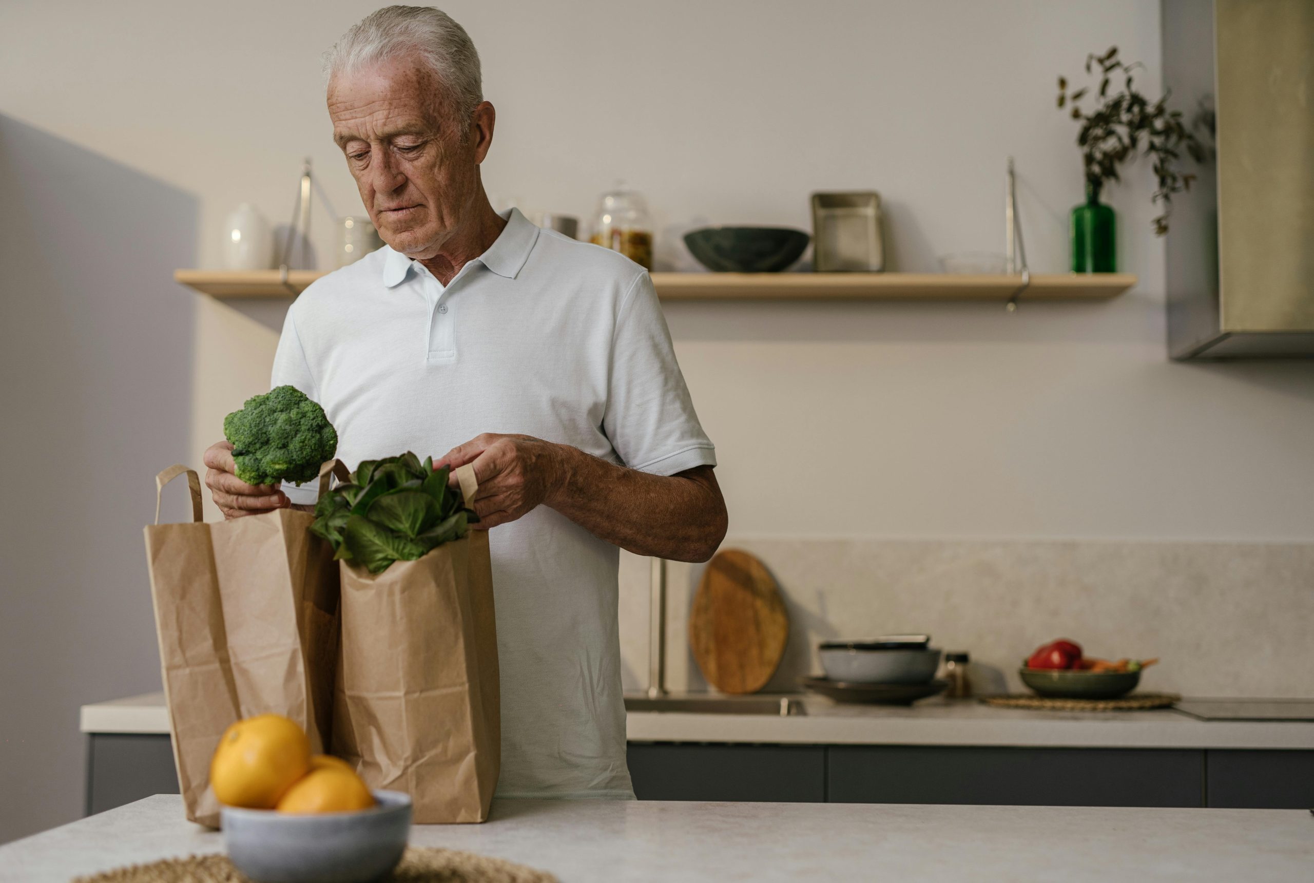 senior unpacking groceries